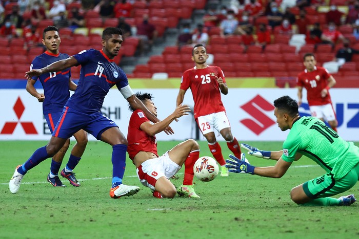 SINGAPORE, SINGAPORE - DECEMBER 25: Goalkeeper Hassan Sunny #18 of Singapore saves an attempt by Witan Sulaeman #8 of Indonesia during the second half of the second leg of their AFF Suzuki Cup semifinal at the National Stadium on December 25, 2021 in Singapore. (Photo by Yong Teck Lim/Getty Images)