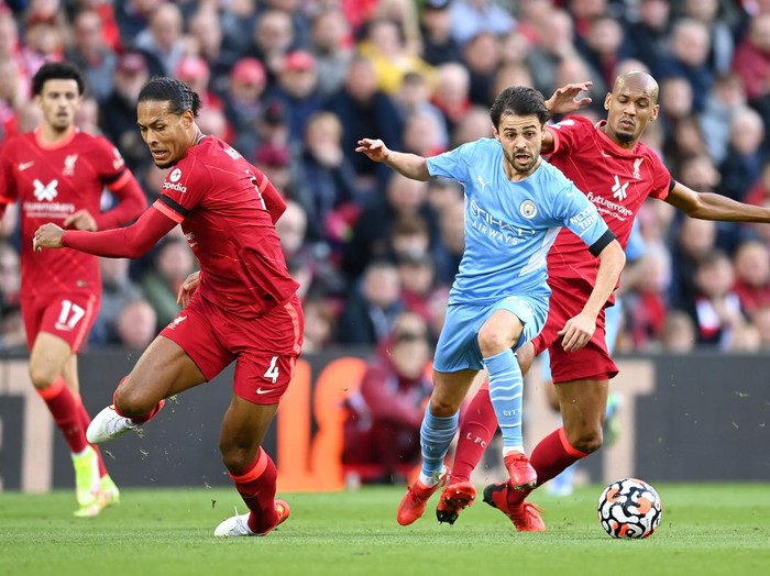 LIVERPOOL, ENGLAND - OCTOBER 03: Bernardo Silva of Manchester City breaks away from Fabinho and Virgil van Dijk of Liverpool during the Premier League match between Liverpool and Manchester City at Anfield on October 03, 2021 in Liverpool, England. (Photo by Michael Regan/Getty Images)