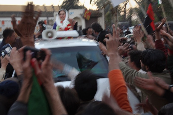 78659900 RAWALPINDI, PAKISTAN - DECEMBER 27: (EDITORS NOTE: Image 1 In A Sequence Of 3 Photos Taken During Blast) A bomb explodes next to the vehicle of former Prime Minister Benazir Bhutto on December 27, 2007 following a political rally in Rawalpindi, Pakistan. The opposition leader has died from a bullet wound to the neck after speaking at a rally in the northern city where an estimated 20 people were left dead by the explosion, a party official and Bhutto's husband have been quoted as saying. (Photo by John Moore/Getty Images)
