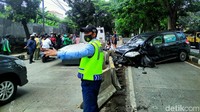 Petugas mengatur kelancaran lalu-lintas. Kecelakaan tersebut menarik perhatian warga sekitar.