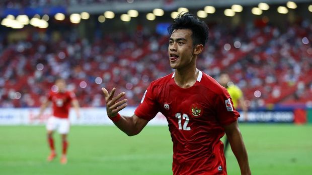 SINGAPORE, SINGAPORE - DECEMBER 25: Pratama Arhan Alif Rifai #12 of Indonesia celebrates after scoring his team's second goal against Singapore during the second half of the second leg of their AFF Suzuki Cup semifinal at the National Stadium on December 25, 2021 in Singapore. (Photo by Yong Teck Lim/Getty Images)