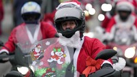 Tak sedikit warga yang berhenti sejenak di pinggir jalan untuk memotret para pemotor yang tengah konvoi mengenakan kostum Sinterklas tersebut. 