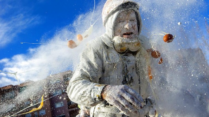 Revellers take part in the Els Enfarinats festival, in the town of Ibi near Alicante, Spain, Tuesday Dec. 28, 2021. For about 200-years the inhabitants of Ibi annually celebrate with a battle using flour, eggs and firecrackers, outside the city town hall. (AP Photo/Alberto Saiz)