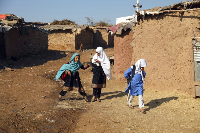 Pakistan Daily Life Afghan refugee schoolchildren attend a class at a makeshift school on the outskirts of Islamabad, Pakistan, Wednesday, Dec. 29, 2021. (AP Photo/Rahmat Gul)