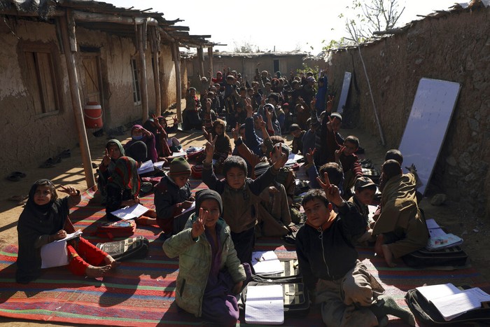 Afghan refugee schoolchildren attend a class at a makeshift school on the outskirts of Islamabad, Pakistan, Wednesday, Dec. 29, 2021. (AP Photo/Rahmat Gul)
