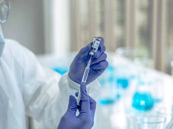 Scientists are done research on vaccine in laboratory with test tubes on Covid19 Coronavirus type for discover vaccine.