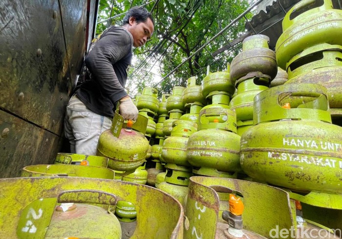Pekerja memindahkan tabung gas LPG 3 kilogram subsidi di salah satu agen gas di kawasan Karet Tengsin, Jakarta, Kamis (30/12/2021). Kenaikan harga LPG nonsubsidi mendorong terjadinya peralihan pola konsumsi masyarakat menjadi lebih memilih gas LPG 3 kilogram bersubsidi atau gas melon, karena memiliki harga yang lebih murah.
