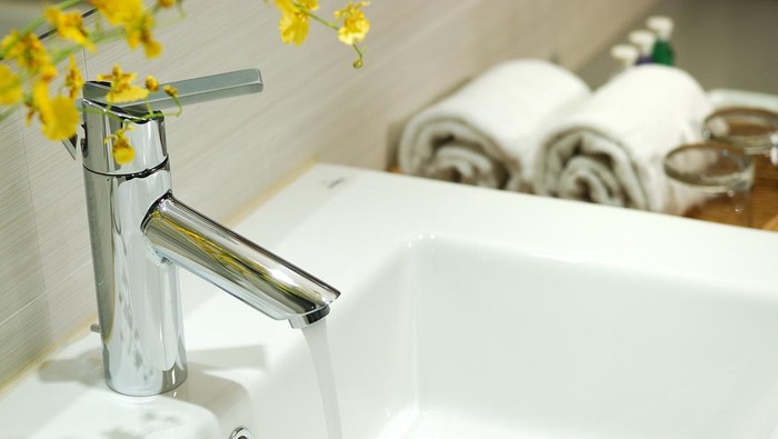 washbasin and faucet in bathroom.Bathroom interior.Towels in bathroom.