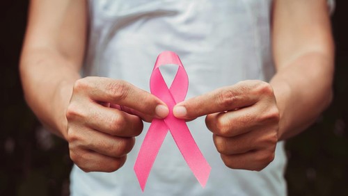 concept healthcare and medicine. hand holding pink ribbon. breast cancer awareness. sign of hope