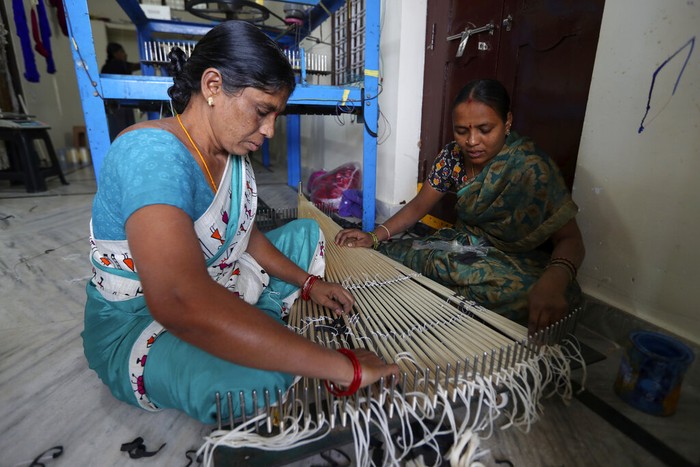 India Silk An Indian weaver prepares silk yarn for dyeing at a small scale handloom factory on the outskirts of Hyderabad, India, Thursday, Dec. 30, 2021. Handloom is one of the largest source of employment in India providing livelihood to more than four million people. (AP Photo/Mahesh Kumar A.)