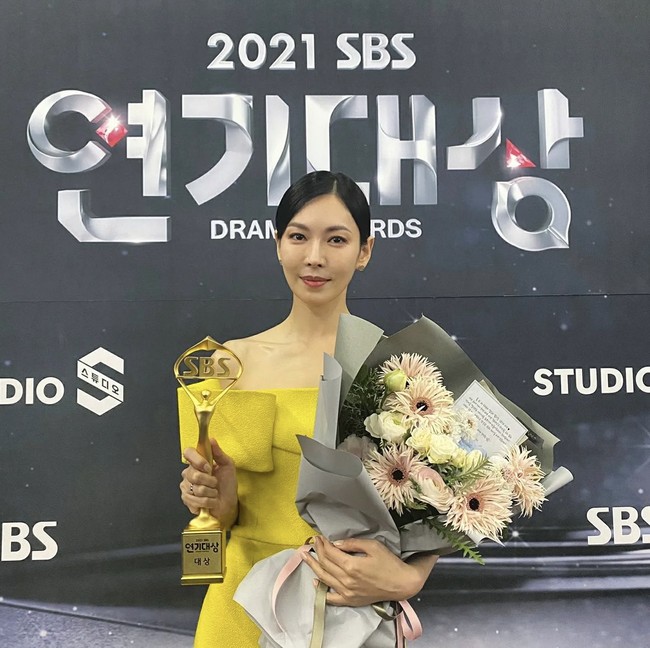Kim So Yeon membawa pulang piala Daesang (Grand Prize) dari SBS Drama Awards. Dia terlihat anggun memakai gaun off shoulder berwarna kuning. Dalam pidatonya, ia menyampaikan terima kasih kepada sutradara dan penulis naskah The Penthouse. Foto: dok. Instagram jwidecompany