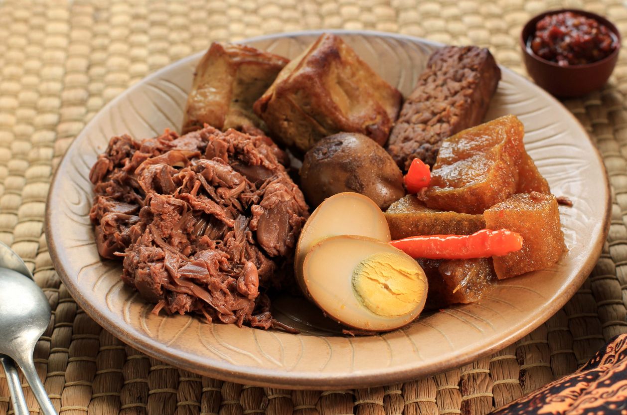 Close Up Gudeg Komplit. A Signature and Legendary Dish from Yogyakarta Indonesia. Jack Fruit Stew Accompanied with Spicy Stew of Cattle Skin Crackers and Brown Eggs, Tofu, Tempeh, and Sambal.