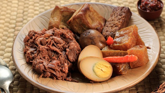 Close Up Gudeg Komplit. A Signature and Legendary Dish from Yogyakarta Indonesia. Jack Fruit Stew Accompanied with Spicy Stew of Cattle Skin Crackers and Brown Eggs, Tofu, Tempeh, and Sambal.