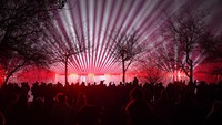 People watch a laser show during New Years celebrations in Bucharest, Romania, Saturday, Jan. 1, 2022. Thousands gathered by a lake to attend a concert and watch fireworks and a laser show during New Years celebrations in the Romanian capital. (AP Photo/Andreea Alexandru)
