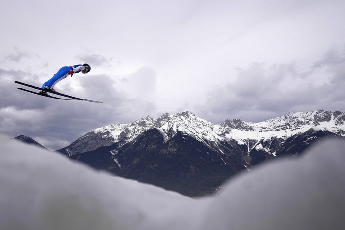 Philipp Aschenwald of Austria soars through the air during his second trial jump at the third stage of the 70th Four Hills ski jumping tournament in Innsbruck, Austria, Monday, Jan. 3, 2022. (AP Photo/Matthias Schrader)