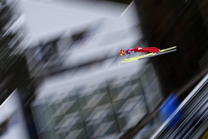 Philipp Aschenwald of Austria soars through the air during his second trial jump at the third stage of the 70th Four Hills ski jumping tournament in Innsbruck, Austria, Monday, Jan. 3, 2022. (AP Photo/Matthias Schrader)
