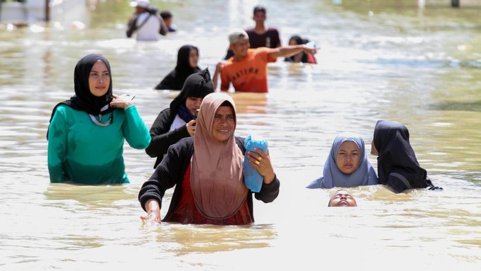 Warga mengangkut pakaian yang terendam banjir ke depan rumah di Desa Meunasah Nga, Lhoksukon, Aceh Utara, Aceh, Selasa (4/1/2022). Data terakhir Badan Penanggulangan Bencana Daerah (BPBD) setempat menyebutkan banjir masih melanda 14 Kecamatan dan jumlah pengungsi terdampak bertambah dari 6.633 Kepala Keluarga (KK) atau 24.332 jiwa menjadi 9.766 KK atau 32.854 jiwa. ANTARA FOTO/Rahmad/tom.
