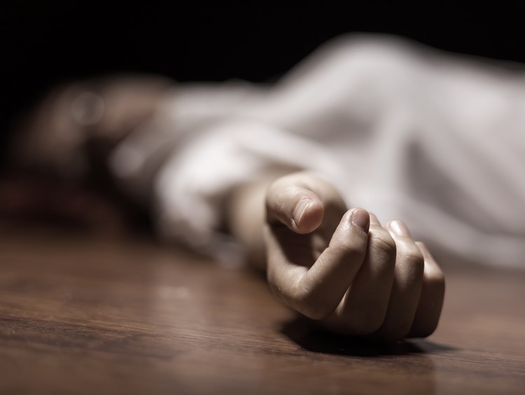 The dead womans body. Focus on hand