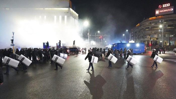 Protesters try to speak to riot police as they gather in the center of Almaty, Kazakhstan, Wednesday, Jan. 5, 2022. Demonstrators denouncing the doubling of prices for liquefied gas have clashed with police in Kazakhstans largest city and held protests in about a dozen other cities in the country. Local news reports said police dispersed a demonstration of about a thousand people Tuesday night in Almaty and that some demonstrators were detained. (AP Photo/Vladimir Tretyakov)