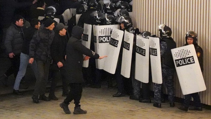 Protesters try to speak to riot police as they gather in the center of Almaty, Kazakhstan, Wednesday, Jan. 5, 2022. Demonstrators denouncing the doubling of prices for liquefied gas have clashed with police in Kazakhstans largest city and held protests in about a dozen other cities in the country. Local news reports said police dispersed a demonstration of about a thousand people Tuesday night in Almaty and that some demonstrators were detained. (AP Photo/Vladimir Tretyakov)