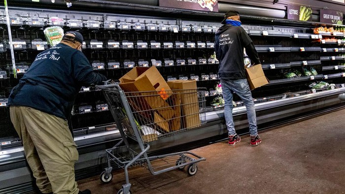 Nearly empty shelves of produce at a supermarket in Washington, Tuesday, Jan. 4, 2022. (AP Photo/Andrew Harnik)