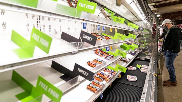 Nearly empty shelves of produce at a supermarket in Washington, Tuesday, Jan. 4, 2022. (AP Photo/Andrew Harnik)