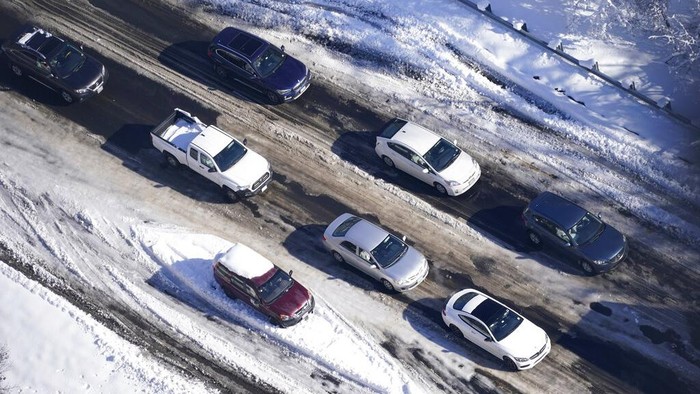 Drivers wait for the traffic to be cleared as cars and trucks are stranded on sections of Interstate 95 Tuesday Jan. 4, 2022, in Carmel Church, Va. Close to 48 miles of the Interstate was closed due to ice and snow. (AP Photo/Steve Helber)