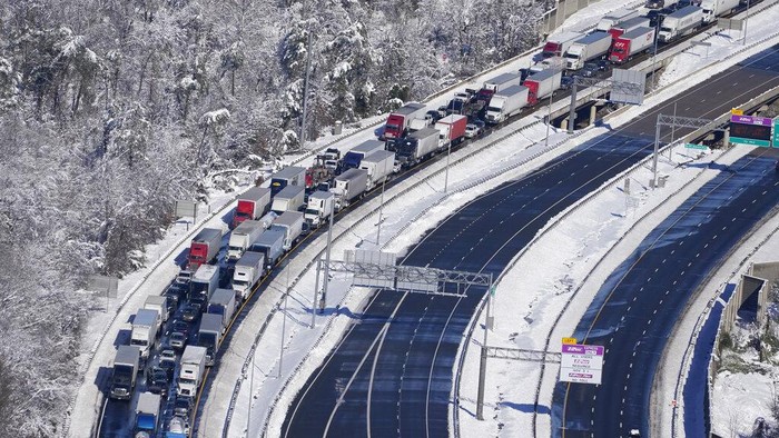 Drivers wait for the traffic to be cleared as cars and trucks are stranded on sections of Interstate 95 Tuesday Jan. 4, 2022, in Carmel Church, Va. Close to 48 miles of the Interstate was closed due to ice and snow. (AP Photo/Steve Helber)