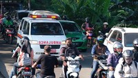 Sebuah ambulans menembus kemacetan akibat truk mogok. 