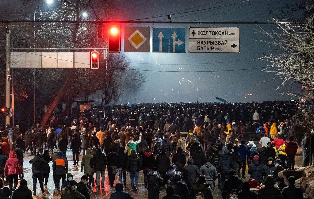 Protesters attend a rally in Almaty on January 4, 2022, after energy price hikes. - Police fired tear gas and stun grenades in a bid to break up an unprecedented thousands-strong march in Almaty, Kazakhstan's largest city, after protests that began over fuel prices threatened to spiral out of control. (Photo by Ruslan PRYANIKOV / AFP)
