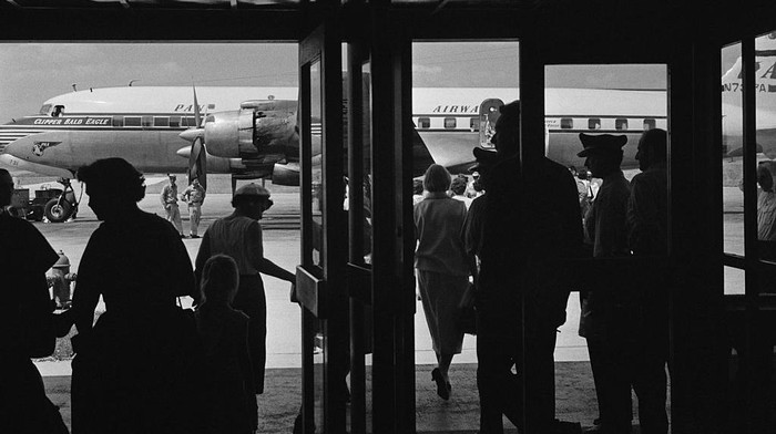 Evacuees from Baghdad about to board a flight at Esenboga Airport, Ankara, Turkey, 25th July 1958. The passengers have left Iraq following the coup détat, also known as the 14 July Revolution, which overthrew the Hashemite monarchy of Iraq. The aircraft is the Douglas DC-7C, Clipper Bald Eagle, of Pan American World Airways (Pan-Am). (Photo by Stroud/Daily Express/Hulton Archive/Getty Images)