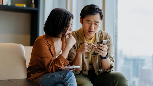 A businessman holding a coin with a tree that grows and a tree that grows on a pile of money. The idea of maximizing the profit from the business investment.