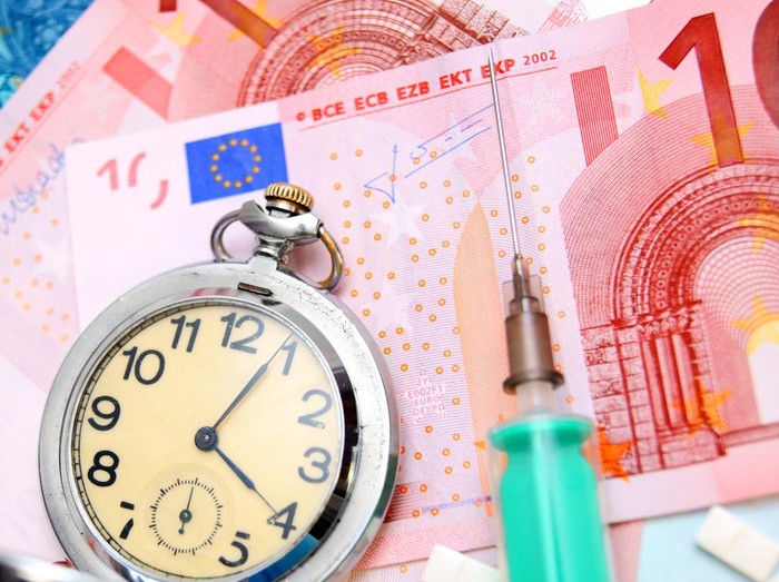 compass and fifty euro banknotes background business and finance concepts