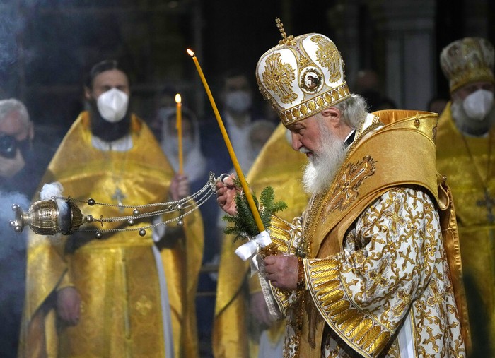 Bishop Dawod Makram wears a face mask, to help prevent the spread of the coronavirus, as he leads the Coptic Orthodox Midnight Mass on Orthodox Christmas Eve at Church of St. George in Cairo, Egypt, late Thursday, Jan. 6, 2022. Copts celebrate Christmas according to the Julian calendar, meaning it falls on Jan. 7. (AP Photo/Amr Nabil)