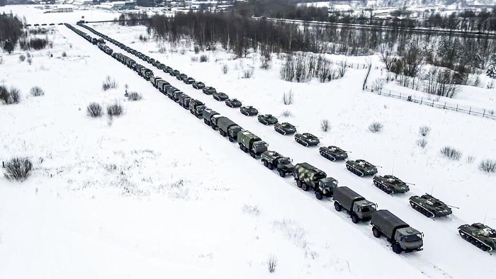 In this image taken from footage provided by the RU-RTR Russian television, Military vehicles of Russian peacekeepers are parked waiting to be uploaded on Russian military planes at an airfield in Russia, Friday, Jan. 7, 2022. Over 70 cargo planes are being deployed in Russia's peacekeeping mission in Kazakhstan according to the Defense Ministry chief spokesman's briefing on Friday, after the worst street protests since the country gained independence three decades ago. The demonstrations began over a near-doubling of prices for a type of vehicle fuel and quickly spread across the country, reflecting wider discontent over the rule of the same party since independence. (RU-RTR Russian Television via AP)