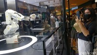 Customer dapat menikmati atraksi robot dalam membuat minuman favorite termasuk shaking cup minuman dingin serta lambaian robot ke customer saat minuman selesai disajikan. 