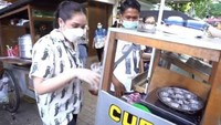 Dari banyaknya jajanan kaki lima, Nagita Slavina menyukai kue cubit. Bahkan ia tertarik untuk membuat kue cubit sendiri di gerobak penjual langsung. Foto: YouTube: Rans Entertainment