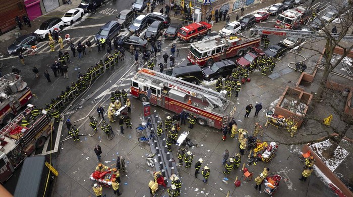 Emergency personnel work at the scene of a fatal fire at an apartment building in the Bronx on Sunday, Jan. 9, 2022, in New York. The majority of victims were suffering from severe smoke inhalation, FDNY Commissioner Daniel Nigro said. (AP Photo/Yuki Iwamura)
