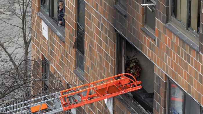 Emergency personnel work at the scene of a fatal fire at an apartment building in the Bronx on Sunday, Jan. 9, 2022, in New York. The majority of victims were suffering from severe smoke inhalation, FDNY Commissioner Daniel Nigro said. (AP Photo/Yuki Iwamura)