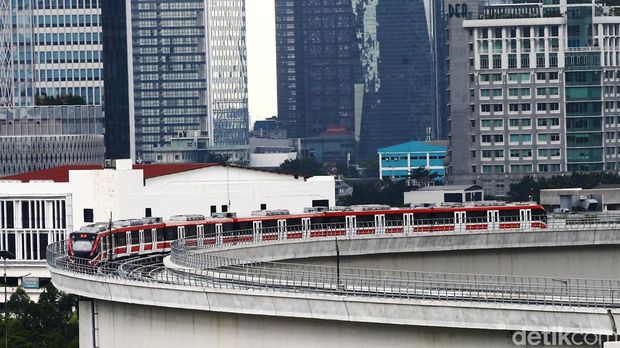 LRT Jabodebek tengah diujicoba. Kereta LRT terlihat melintas di Jalan Gatoto Subroto dan melewati flyover lengkung Kuningan, Jakarta Selatan, Senin (10/1).