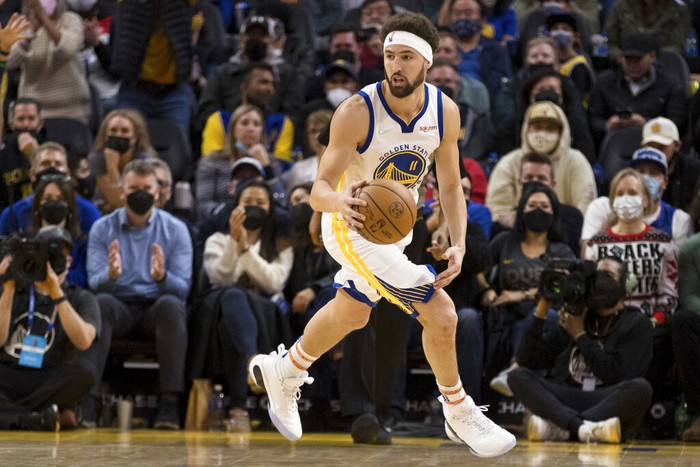 Golden State Warriors guard Klay Thompson (11) takes the ball down court against the Cleveland Cavaliers during the second half of an NBA basketball game in San Francisco, Sunday, Jan. 9, 2022. (AP Photo/John Hefti)