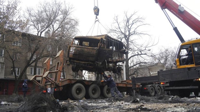 A crane loads a military truck, which was burned during clashes onto the platform in Almaty, Kazakhstan, Sunday, Jan. 9, 2022. Kazakhstans health ministry says at least 164 people have been killed in protests that have rocked the country over the past week. President Kassym-Jomart Tokayevs office said Sunday that order has stabilized in the country and that authorities have regained control of administrative buildings that were occupied by protesters, some of which were set on fire. (Vladimir Tretyakov/NUR.KZ via AP)