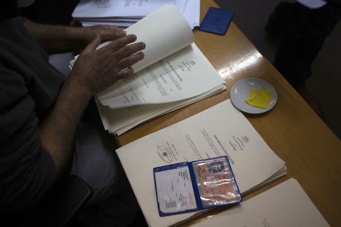 Israel Palestinian IDs Palestinians wait to receive their official population register letters at the civil affairs office in Gaza City, Monday, Jan. 3, 2022. In recent months,Β IsraelΒ has approved residency for thousands of Palestinians in the occupied West Bank and Gaza, allowing them to get an official Palestinian ID number that grants them the possibility to travel abroad and clear up years of uncertain legal status. (AP Photo/ Khalil Hamra)