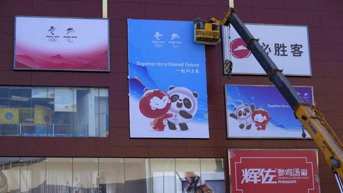 A resident is silhouetted as she exercises with a colored ribbon in Beijing, China, Tuesday, Jan. 11, 2022. The Chinese capital is on high alert ahead of the Winter Olympics as China locks down a third city elsewhere for COVID-19 outbreak. (AP Photo/Ng Han Guan)