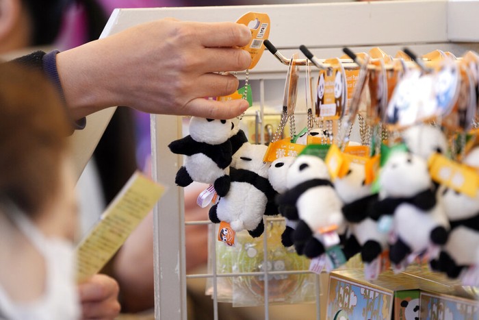 Japan Panda Souvenir products of the twin giant pandas Xiao Xiao and Lei Lei are sold at a shop Wednesday, Jan. 12, 2022, at Ueno Zoo. in Tokyo. Twin panda cubs made their long-awaited first public appearance Wednesday before their devoted fans but only limited to three days as their zoo has to close amid the upsurge of the highly transmissible coronavirus variant. (AP Photo/Eugene Hoshiko)