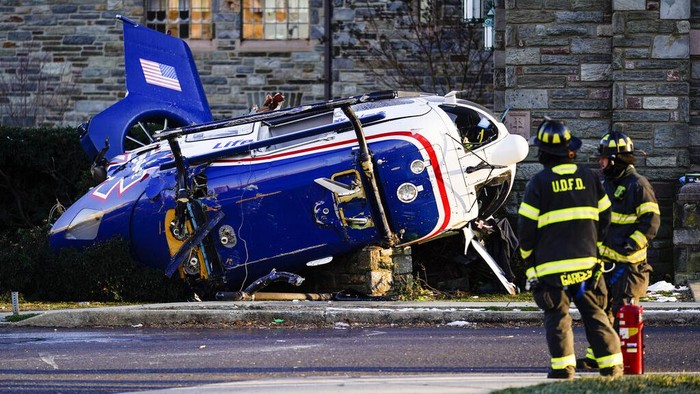 A medical helicopter rests next to the Drexel Hill United Methodist Church after it crashed in the Drexel Hill section of Upper Darby, Pa., on Tuesday, Jan. 11, 2022. (AP Photo/Matt Rourke)