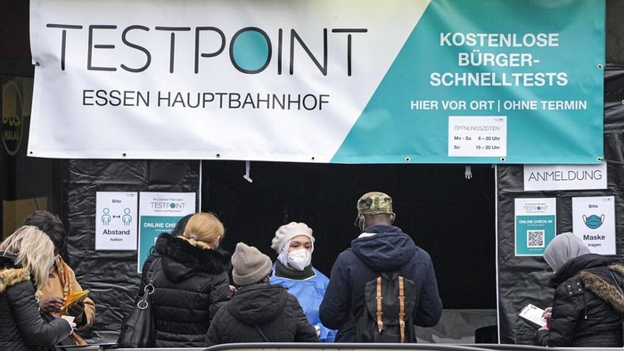 People make corona tests in the city center of Essen, Germany, Wednesday, Jan. 12, 2021. Germany registered a new record of more than 80,000 new infections with the coronavirus on Wednesday. (AP Photo/Martin Meissner)