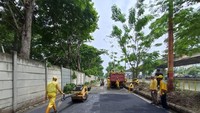 Tampak beberapa petugas Bina Marga Jakarta Utara tengah memperbaiki jalan yang rusak. (Wildan-detikcom)