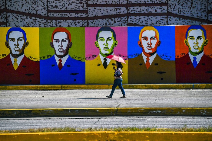 Hugo Chavez A boy pulls a suitcase on wheels as he walks past a mural of the late Venezuelan President Hugo Chavez in Chavez's hometown of Sabaneta, in Barinas state in Venezuela, Friday, Jan. 7, 2022. The country's highest court disqualified opposition candidate Freddy Superlano as he was leading the count in November's gubernatorial election in Barinas, apparently defeating Argenis Chavez, the brother of late President Hugo Chavez's, and ordered a re-run on Jan. 9. (AP Photo/Matias Delacroix)
