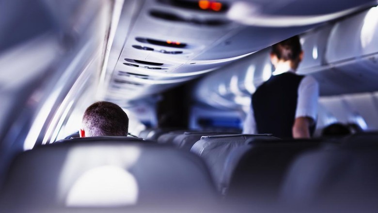 Penumpang pesawat Airplane cabin during flight. Shallow DOF, selective focus.
